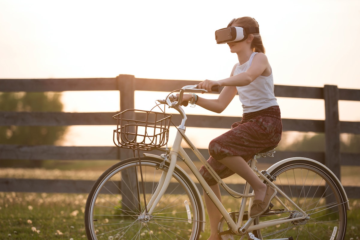 A woman not at all dangerously wearing a VR headset while riding a bike. Photo by Sebastian Arie Voortman.